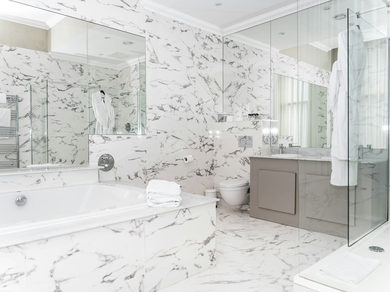 Luxury marble bathroom with freestanding tub and vanity
